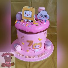 a pink birthday cake with two cartoon characters on it