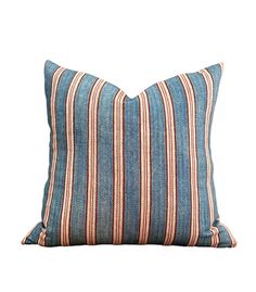 a blue and red striped pillow on a white background