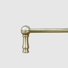 an image of a brass handle on a door knob or curtain rod in the shape of a ball and twig