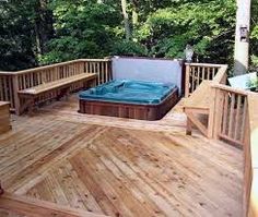 a hot tub sitting on top of a wooden deck