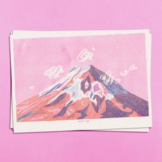 a postcard with an image of a mountain in pink and blue on it's side