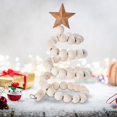 a christmas tree made out of egg shells with a star hanging from it's top