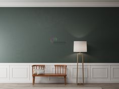 an empty room with a bench and lamp on the floor in front of green walls