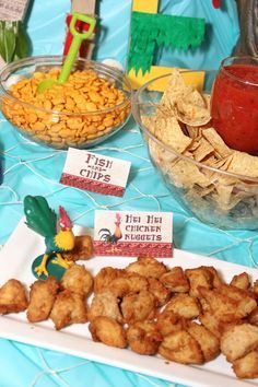 a table topped with bowls filled with food and other items on top of a blue table cloth