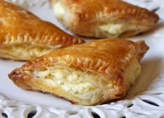 two pastries on a white plate sitting on a table