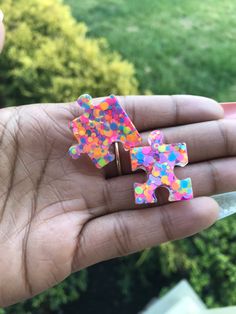 a person holding a piece of puzzle in their hand