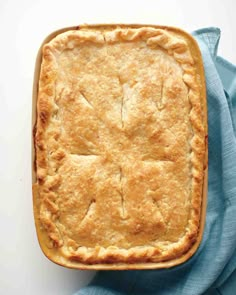 a baked pie sitting on top of a blue cloth