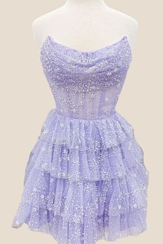 This dress features a beautiful Lavender color and is made from Tulle material, making it lightweight and airy. The A-line silhouette is flattering and the Corset bodice with strapless neck adds support and style. The skirt is designed with tiered ruffles for a playful touch, and the back zips up for convenience. Perfect for any party, this dress falls above the knee for a fun and flirty look. Short Lavender Dress, Classy Homecoming Dress, Dresses For Dances, Short Princess Dress, Cute Formal Dresses, Dama Dresses, Tulle Material, Cute Homecoming Dresses, Tulle Homecoming Dress