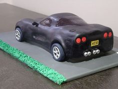 a black car cake sitting on top of a table