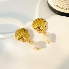 Experience the beauty of the ocean with our stunning 18K Seashell Freshwater Pearl Earrings. These earrings feature delicate seashell pendants and lustrous freshwater pearls, creating a fashionable yet timeless look. Crafted with high-quality stainless steel, these earrings are perfect for any beach lover or fashion enthusiast. Elevate your style with our 18K Seashell Freshwater Pearl Earrings today! Seashell Pendants, Freshwater Pearl Earrings, Fashion Enthusiast, Beach Lover, Freshwater Pearls Earrings, Beach Lovers, Pearl Drop, The Ocean, Fresh Water