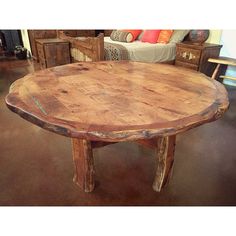 a wooden table sitting on top of a floor next to a bed and dressers