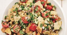 a white plate topped with salad and tortilla chips