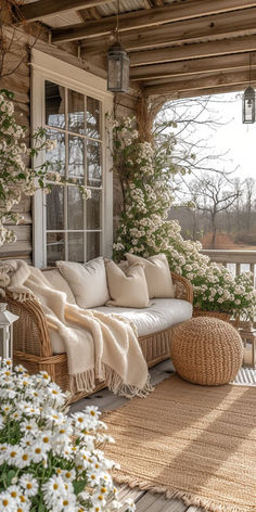 a porch covered in wicker furniture and flowers