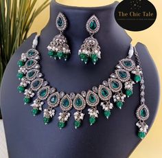 This Emerald Green Polki Kundan Moti Jewelry Set is made with copper-based materials and finished with a silver coating. Adorned with stunning emerald green stones, this set will add an elegant touch to any outfit. Its anti-tarnish properties ensure long-lasting beauty. Perfect for a formal occasion or as a statement piece. Emerald Green Stone, Green Stones, Green Stone, The Chic, Formal Occasion, Emerald Green, Jewelry Set, Statement Pieces, Emerald