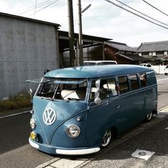 an old vw bus is parked on the side of the road