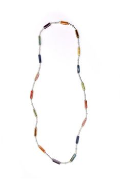 Add a touch of sophistication to any outfit with our Long Jewel Tone Necklace. The durable piano wire design and eye-catching jewel toned beads make it a unique and versatile accessory. Elevate your style with this elegant necklace! No Clasp Not Adjustable Bead Size: 1 inch Necklace Length: 36 inches Modern Metal Necklaces With Beaded Chain, Modern Metal Necklace With Beaded Chain, Modern Jewelry With Colorful Beads, Elegant Multicolor Metal Beaded Necklaces, Modern Silver Beaded Necklace, Modern Beaded Necklaces, Elegant Glass Wire Wrapped Necklaces, Multicolor Wire Wrapped Metal Necklaces, Vibrant Beaded Adjustable Necklace