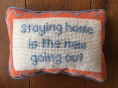 a cross stitch pillow that says, stronging home is the best thing out there