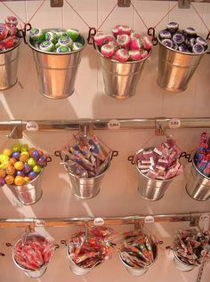 several buckets filled with candy sitting next to each other