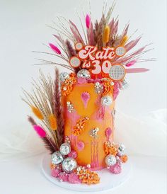 a cake decorated with feathers and decorations for a 30th birthday party or special occasion to celebrate