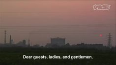 the sun is setting over an industrial area with power lines in the background and a message written below it