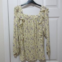 Chaps Long Sleeved Blouse, Ladies Size Medium, Yellow With Purple And Green Floral Print. 27" Long, 27" Bust, 24" Length Sleeves With Elastic At Wrists. Pretty Ruffles At Shoulders And Square Neckline. 85% Cotton 45% Viscose. Never Worn, Tags Still Intact. Smoke Free Home. Yellow Ruffled Long Sleeve Tops, Spring Yellow Floral Print Top, Yellow Floral Print Top For Spring, Yellow Ruffled Blouse For Day Out, Fitted Yellow Blouse For Daywear, Spring Yellow Floral Print Blouse, Yellow Floral Print Blouse For Spring, Yellow Long Sleeve Tops For Spring, Yellow Tops For Daytime In Spring