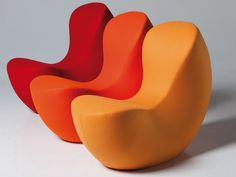 three orange and red chairs sitting next to each other