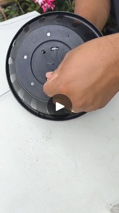 a person is removing the lid off of a dishwasher that has been placed on top of a table