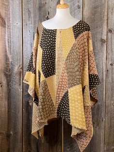 "This poncho is made with a beautiful piece of amber colored Mudcloth. This textile is made with the traditional natural dyes but using modern art style. The handwoven, hand dyed cloth is from Mali. May be styled in either direction. This will fit a size Large to 2X. 49\" W 33\" L There are more on our Etsy site in different patterns to choose from. Each one is unique and one of a kind... DM us for custom orders. Bògòlanfini, or \"Mud cloth,\" is a handmade Malian cotton fabric traditionally dye Oversized Brown Bohemian Cape, Oversized Brown Bohemian Poncho, Bohemian Yellow Poncho One Size, Yellow Bohemian One Size Poncho, Yellow Bohemian Poncho One Size, Yellow Bohemian One-size Poncho, Oversized Brown Poncho For Festivals, Yellow Bohemian Poncho For Fall, Brown Bohemian Cape Poncho