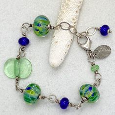 Bracelet: Lime and Blue Handmade Artisan Glass – Bluemangroveart Handmade Beaded Bracelets In Sterling Silver With Fusion Style, Adjustable Blue Fusion Beaded Bracelets, Adjustable Blue Beaded Fusion Bracelets, Adjustable Blue-green Beaded Jewelry, Artistic Blue Beaded Jewelry, Artisan Blue Sterling Silver Bracelets, Adjustable Blue Jewelry With Recycled Glass, Adjustable Large Bead Sterling Silver Jewelry, Adjustable Large Beads Sterling Silver Jewelry