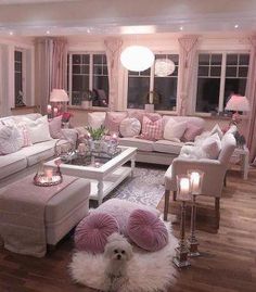 a living room filled with lots of furniture and pink pillows on top of it's walls