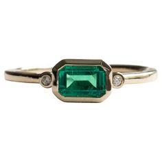 East west emerald stone bezel with diamonds set on 14k yellow gold. Stone Shape: Emerald Stone Type: Lab-created emerald Metal Type: 14 Karat Yellow Gold Stone size: 4mm x 6mm Band width: 1.7mm Diamond Clarity: VS Diamond Color: G-H Size 7 is ready to ship Art Deco Baguette Ring, Masculine Engagement Rings, Green Stone Ring, Emerald Ring Engagement Diamond, Bezel Set Engagement Ring, Emerald Rings, Engagement Ring Art Deco, Green Stone Rings, Bezel Set Ring