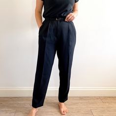 NEW, neat, smart vintage ladies trousers in jet black. They have a tapered leg, mid-high waist, front pleats and pockets, a skinny matching belt and it fastens with a zip and a button. The fabric polyester with Lycra so they have a slight stretch, are crease resistant and fall beautifully. A smart, flattering pair of trousers suitable for work or everyday wear. Made in the U.K. by St.Michael, in 1997. 98% polyester, 2% elastane Lycra. Medium size, labelled as 14UK/42EUR. Measurements when laid f Classic Tapered Pants With Belt Loops, Elegant Tapered Bottoms For Business Casual, Classic Workwear Bottoms With Belt Loops, Classic Bottoms With Belt Loops For Work, Classic Tapered Formal Bottoms, Classic Office Bottoms With Belt Loops, Classic Bottoms With Belt Loops For Office Wear, Classic Straight Leg Belted Pants, Classic Belted Pants For Workwear