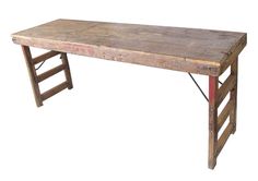 an old wooden table with two ladders on the bottom and one leg up against it