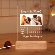 a wooden desk with a calendar on it and a couple kissing in the background, next to a string of twine