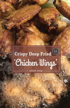 crispy deep fried chicken wings in a frying pan with text overlay that reads crispy deep fried chicken wings