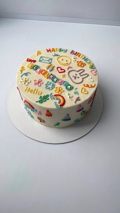 a birthday cake decorated with colorful images on it