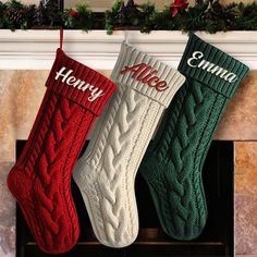 three christmas stockings hanging from a mantel with the word merry written on them in red, green and white