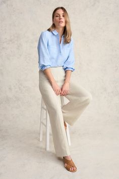 This 100% French linen shirt with natural shell buttons and elasticated cuffs is a light and breathable addition to any outfit. In addition to classic shirt details, it features intricate picot detailing along the pocket and hem. Available in Chambray Cross Dye, this shirt pairs perfectly with our signature Bengajean®. Relaxed Fit Blouse With Button Cuffs For Casual Gatherings, Linen Blouse With Button Cuffs For Work, Casual Long Sleeve Flax Blouse, Flax Button-up Tops For Spring, Spring Workwear Flax Blouse, Spring Workwear Blouse In Flax Color, Spring Flax Button-up Top, Flax Blouse For Spring Workwear, Spring Shirt With Button Cuffs For Casual Gatherings