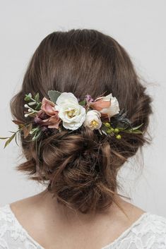 a woman with flowers in her hair wearing a flower headpiece on her wedding day