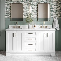 a bathroom with two sinks, mirrors and wallpaper on the walls in green tones