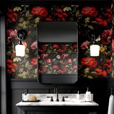 a bathroom with black walls and floral wallpaper on the vanity, along with two sinks