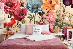 a bedroom decorated with colorful flowers on the wall