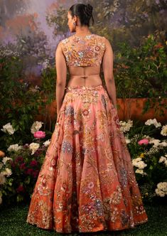 Adding the tone of regality to your celebrations this Zara lehenga set is the apt pick. The shade of coral pink alluring from the bottom of the lehenga skirt merges with the coral pink hue making an enthralling melange. The floral intricacies adorn the whole set accentuating those hand-prints along with the use of dazzling nalki beads and sequins. Half-sleeve V-neck blouse attached with straps that go at the back tying up the blouse with an attached metal hook. The flowy embroidered translucent Gazal Gupta Lehenga, Beads And Sequins Embroidery, Gazal Gupta, Coral Blouse, Hand Prints, Lehenga Skirt, Desi Girl, The Coral, Sequins Embroidery