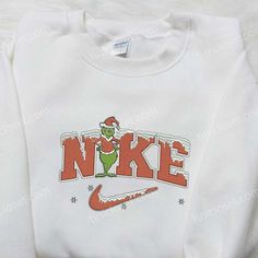 Introducing the Christmas Grinch x Nike Embroidered Shirt, a festive must-have for the holiday season! Designed with meticulous attention to Christmas Gift Images, Nike Inspired, Baby Grinch, Embroidered Apparel, Christmas Attire, Christmas Grinch, Funny Christmas Sweaters, Cute Shirt Designs, Nike Sweater