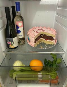 there is a cake and wine in the refrigerator