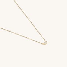 Elevate your style with our Minimal Baguette Necklace. The sleek baguette-cut pendant, suspended from a delicate gold chain, exudes timeless elegance. With its minimalist design and fine craftsmanship, this necklace effortlessly transitions from day to night, making it a versatile and refined addition to your collection. Whether worn solo or layered, it's a symbol of enduring beauty and impeccable taste. - Made in 14k solid gold - Decorated with handset white cubic zirconia stone on 14k solid go Chic Yellow Gold Necklaces For Evening, Elegant Diamond Necklace With Rectangular Pendant For Formal Occasions, Luxury Baguette Necklace For Formal Occasions, Elegant Gold Necklace With Baguette Shape, Elegant Gold Baguette Cut Necklace, Elegant Evening Necklaces With Baguette Cut, Elegant Gold Baguette Necklace, Elegant Evening Necklace With Baguette Cut, Elegant Baguette Cut Necklace For Evening