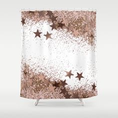 a shower curtain with stars on it in pink and gold glitter, against a white background