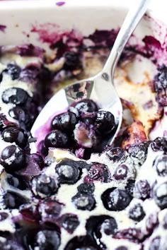 blueberries and cream in a bowl with a spoon