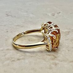 Beautiful 14 karat yellow gold cocktail ring featuring 3 natural oval citrines. The gemstones weigh approximately 3.6 carats, and are accented by 20 diamonds weighing approximately 0.08 CTTW. Citrine is the birthstone for November! Weighs 3.3 grams. Size 7 US / N 1/2 - O UK. > Resizing included. This ring can be resized to fit most fingers. Please contact us for details. Resized rings are final sale. Free resizing does not apply to discounted rings over 15% off. Birthstone: November/April. Condi Gold Oval Citrine Diamond Ring, Oval Yellow Gold Topaz Ring With Diamond Accents, Oval Topaz Ring With Citrine Accents, Oval Topaz Ring With Diamond Accents In 14k Gold, Oval Citrine Diamond Ring, Elegant Oval Topaz Three Stone Ring, Oval Citrine Diamond Ring With Accent Stones, Three Stone Gold Topaz Ring For Formal Occasions, Formal Gold Three Stone Topaz Ring