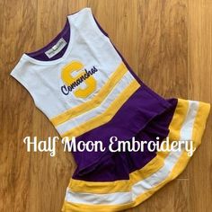 Personalized Purple Gold and White Cheer Uniform Fitted Team Name Tops For Cheerleading, Fitted Cheerleading Top, Fitted Tops With Team Name For Cheerleading, Fitted Tops For Cheerleading With School Spirit, Collegiate White Tops With Custom Embroidery, White Collegiate Top With Custom Embroidery, White Fitted Tops For Cheerleading, Fitted White Tops For Cheerleading, White Fitted Tops With Custom Embroidery